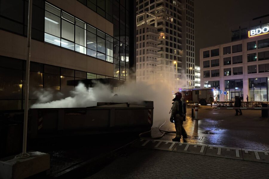 Bouwcontainer in brand vlakbij gebouw